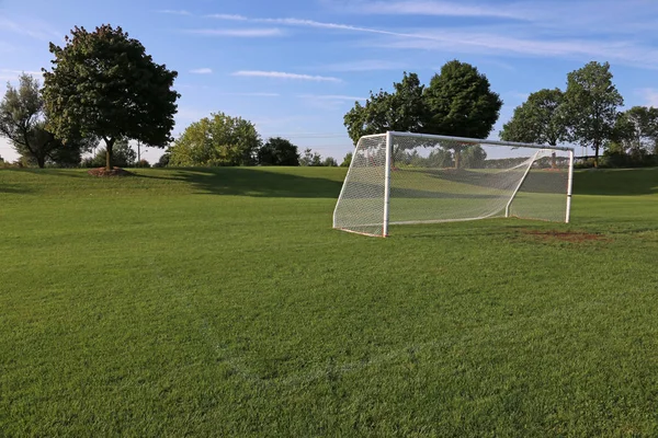 朝の光で空いているサッカーを観網のピッチします — ストック写真