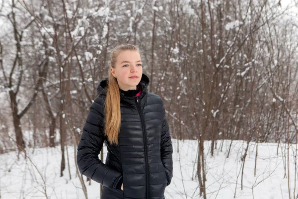 Retrato de invierno de una linda mujer joven en el parque de nieve —  Fotos de Stock