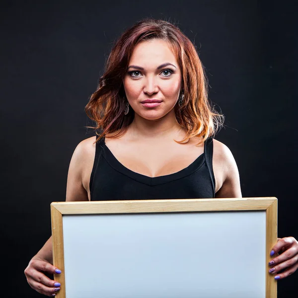 Pretty young girl holding whiteboard — Stock Photo, Image