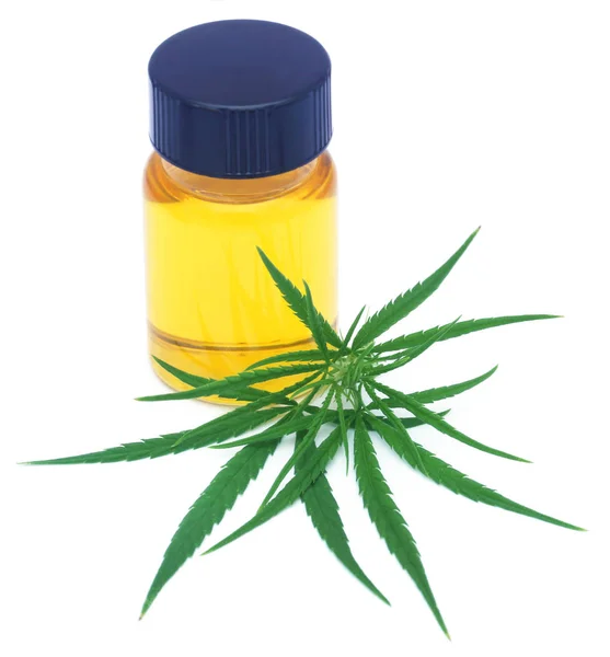 Medicinal cannabis leaves with extract oil in a bottle — Stock Photo, Image