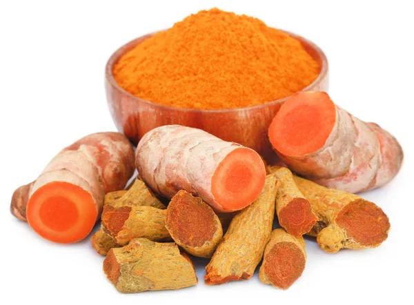 Whole and ground turmeric in bowl — Stock Photo, Image