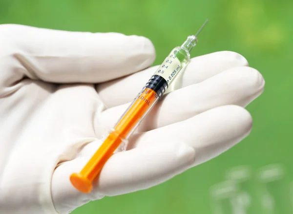 Hand holding a syringe — Stock Photo, Image