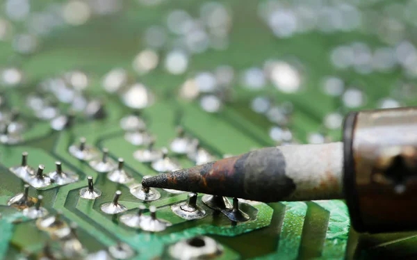 Television motherboard with soldering iron — Stock Photo, Image