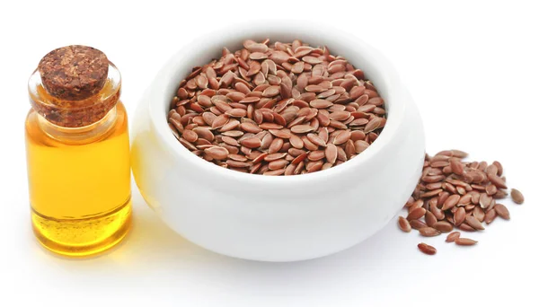 Flax seeds and oil in a jar — Stock Photo, Image