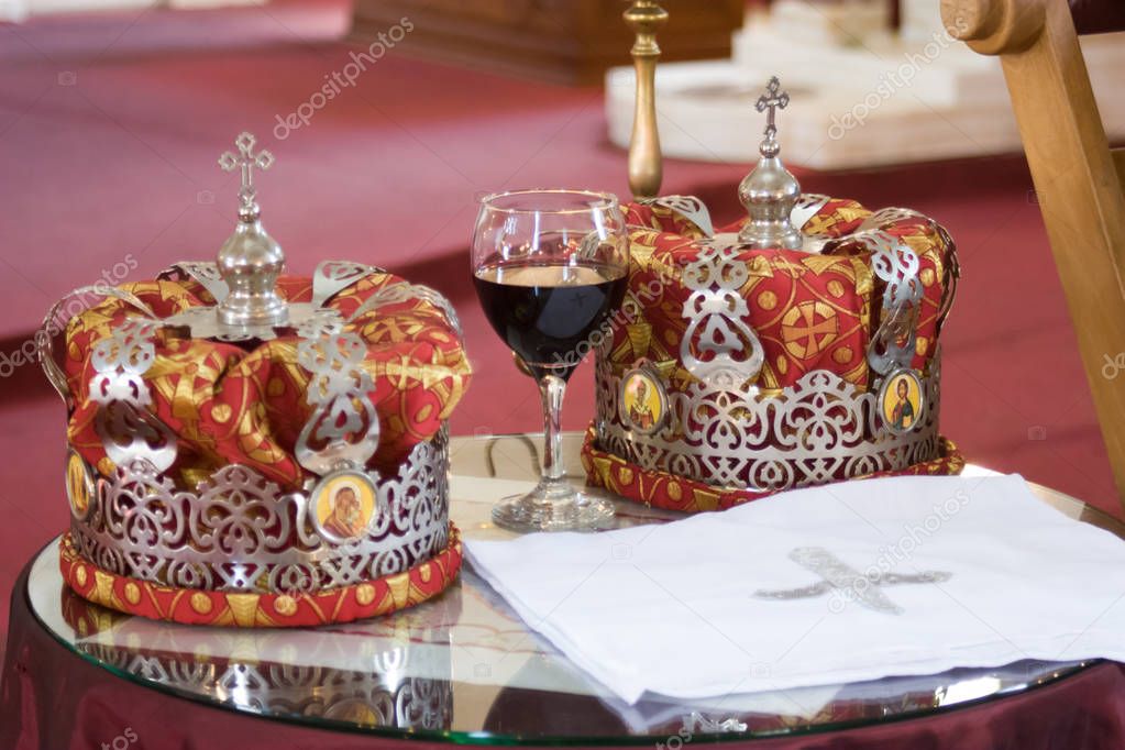 Wedding crowns and glass of  wine church