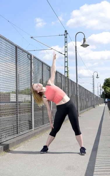 Young woman stretching — Stock Photo, Image