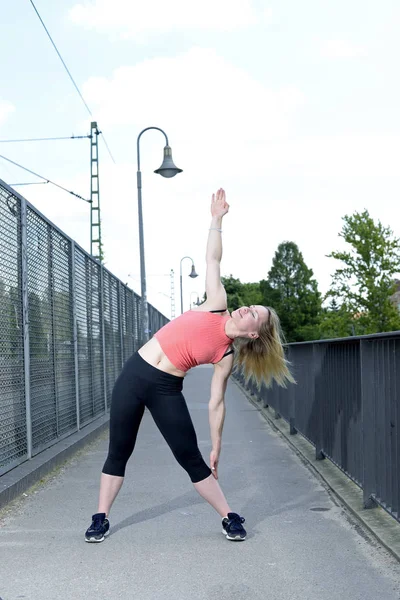 Young woman stretching — Stock Photo, Image