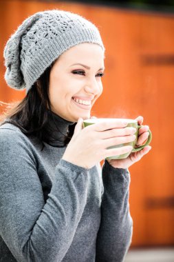 Güzel genç bayan çay içiyor.