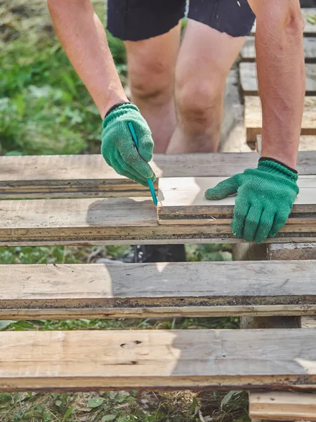 Builder drawing on a wooden board