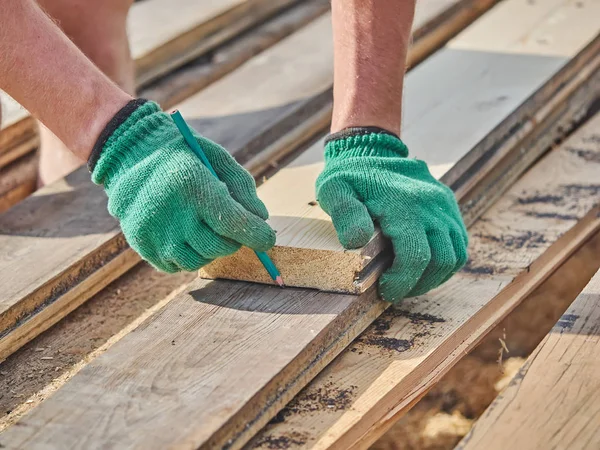 Builder drawing on a wooden board