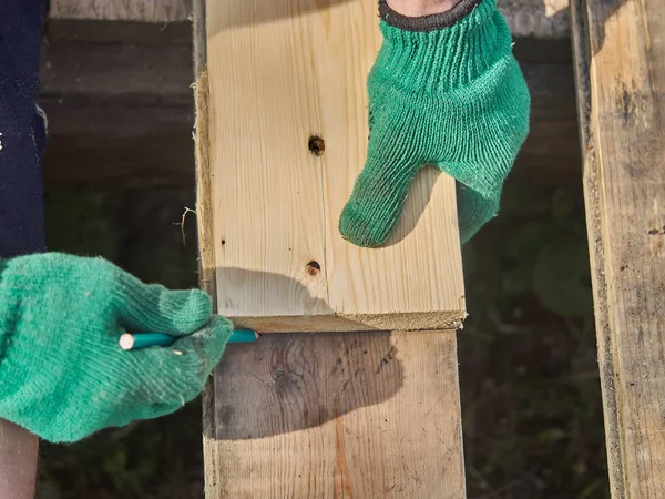 Builder drawing on a wooden board