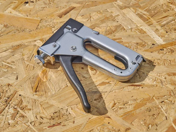 Construction stapler on a wooden background — Stock Photo, Image