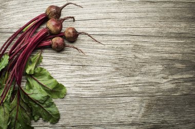 Raw Beetroot on wooden table clipart