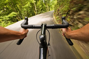 Cycling on road in nature clipart