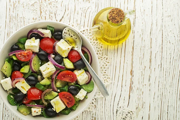 Salad with feta cheese and fresh vegetables isolated on white background. Greek salad.