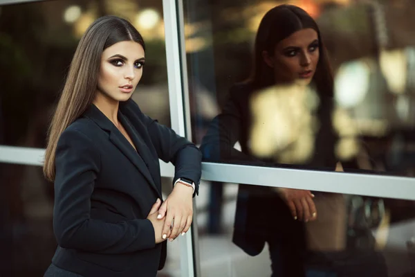 Portrait of fashion business woman near big windows