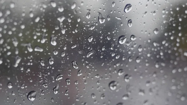 Rain falling on glass during rain storm