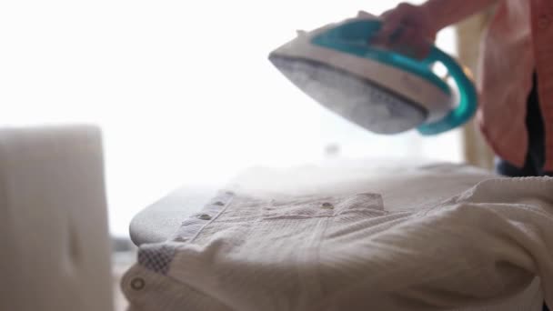 Male hands ironing clothes with iron on ironing board. slow motion — Stock Footage Male hands ironing clothes with iron on ironing board. slow motion Stock Footage