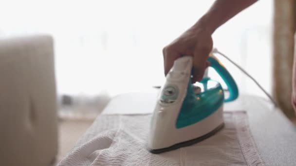 Close up of male hands ironing clothes with iron on an ironing board. slow motion — Stock Footage Close up of male hands ironing clothes with iron on an ironing board. slow motion Stock Footage