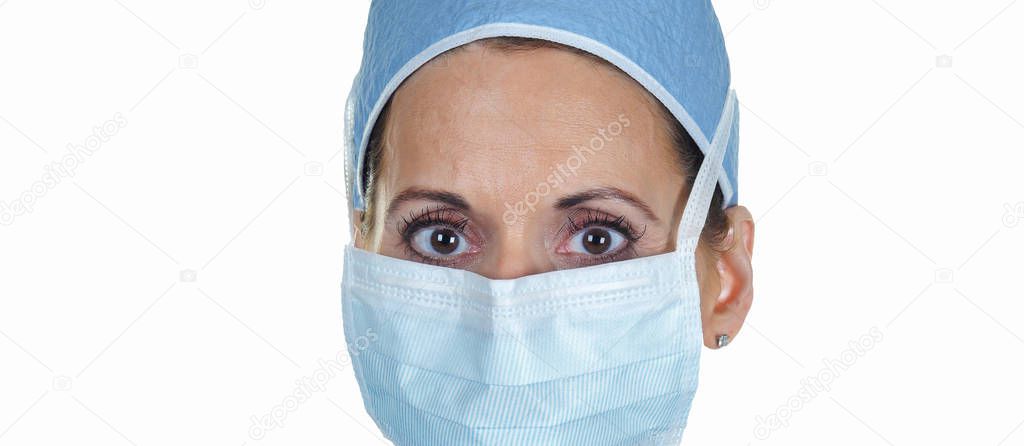 Female Doctor or Nurse Wearing a Face Mask as part of the Protective Gear used against the Coronavirus.  