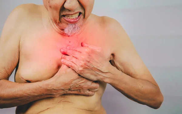 Acute pain possible heart attack, senior man is clutching he chest. — Stock Photo, Image