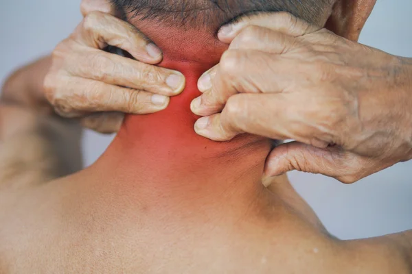 Senior man hand holding he neck and massaging in pain area. close up — Stock Photo, Image