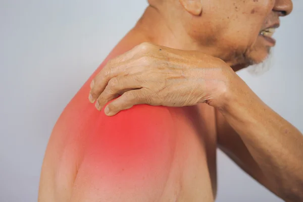 Senior man holding he shoulder on pain area — Stock Photo, Image