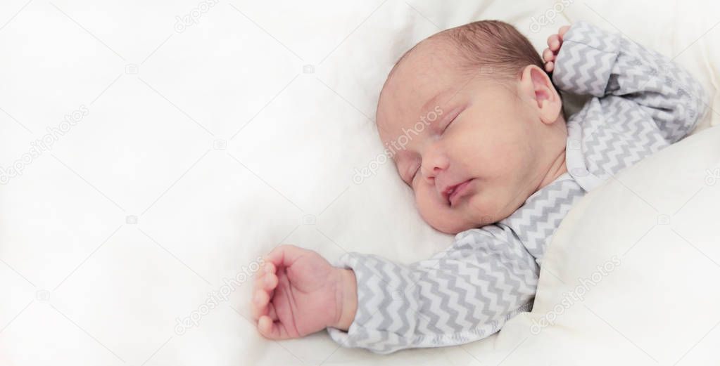 Cute newborn baby sleeping, one month old, with space for text