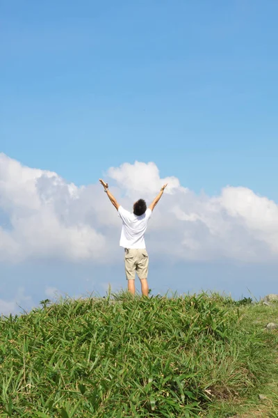 Meeting of the sky. The man on high mountain with the hands lift — Stock Photo, Image