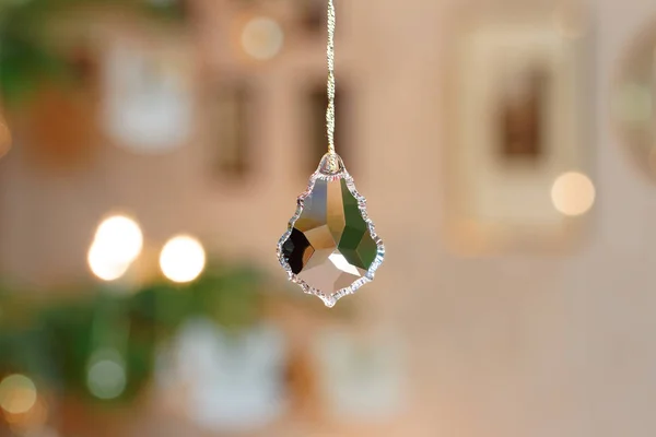 Abgeschrägter Glaskristall vor weihnachtlichem Bokeh-Hintergrund — Stockfoto