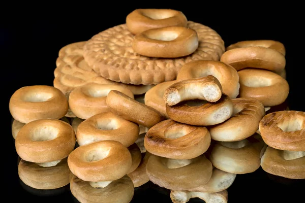 Cookies and small bagels on a black — Stock Photo, Image