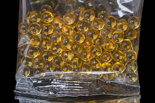 Plastic bag with granules fish oil — Stock Photo, Image