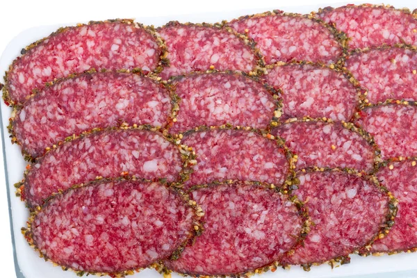 Sliced smoked sausage on a white tray — Stock Photo, Image