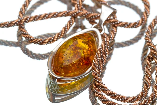 Pendant with amber on a gold chain — Stock Photo, Image