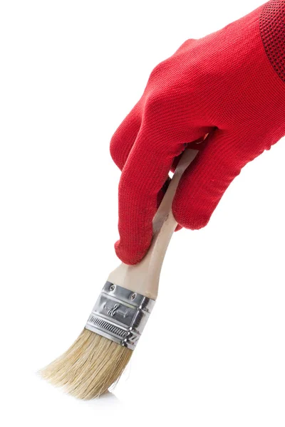 Hand in a red glove and  paintbrush — Stock Photo, Image