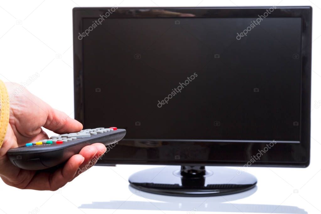 Hand with remote control and TV