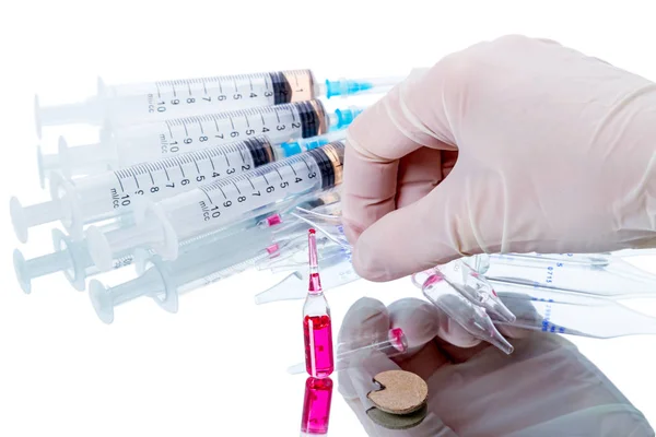 Human hand and used syringes and vials — Stock Photo, Image