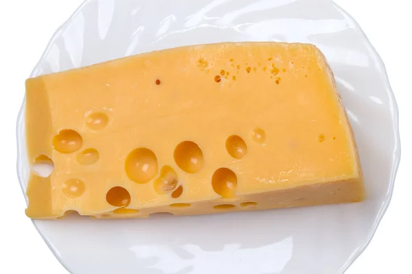 Pezzo di formaggio su un piatto bianco — Foto Stock