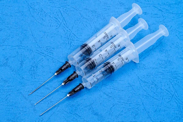 Used syringes on blue — Stock Photo, Image