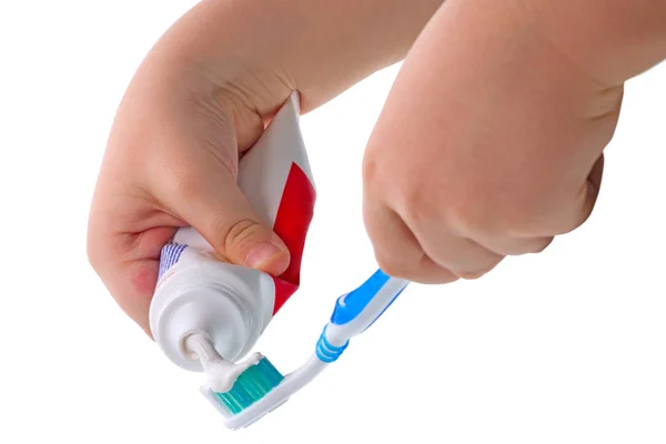 Child hand and toothpaste — Stock Photo, Image
