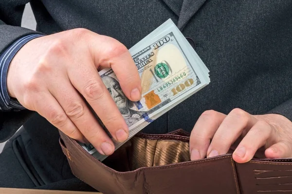 Businessman puts in a wallet — Stock Photo, Image