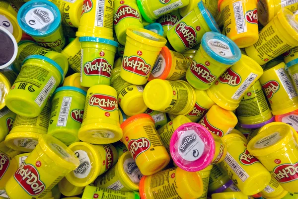 Heap of Play-Doh containers with difrent color  modeling compoun — Stock Photo, Image