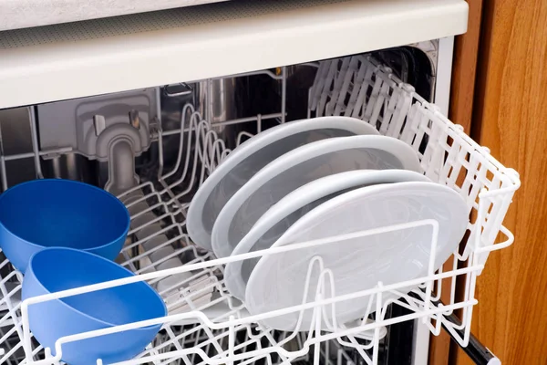 Open dishwasher with plates