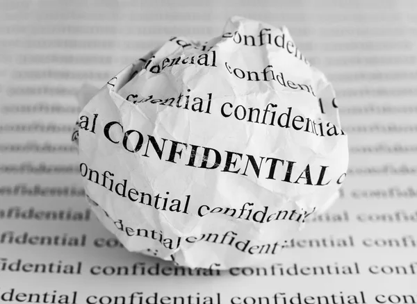 Crumpled paper ball with words Confidential — Stock Photo, Image