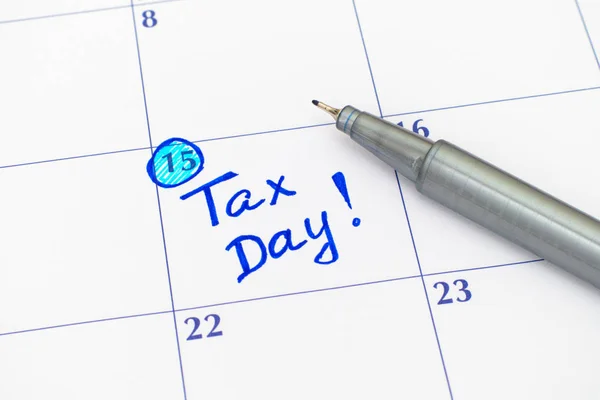 Reminder Tax day in calendar with pen