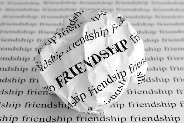 Crumpled paper ball with words Friendship — Stock Photo, Image