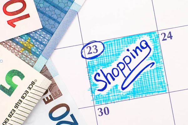 Recordatorio Compras en calendario con billetes en euros —  Fotos de Stock
