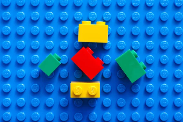 Five Lego blocks on blue baseplate — Stock Photo, Image