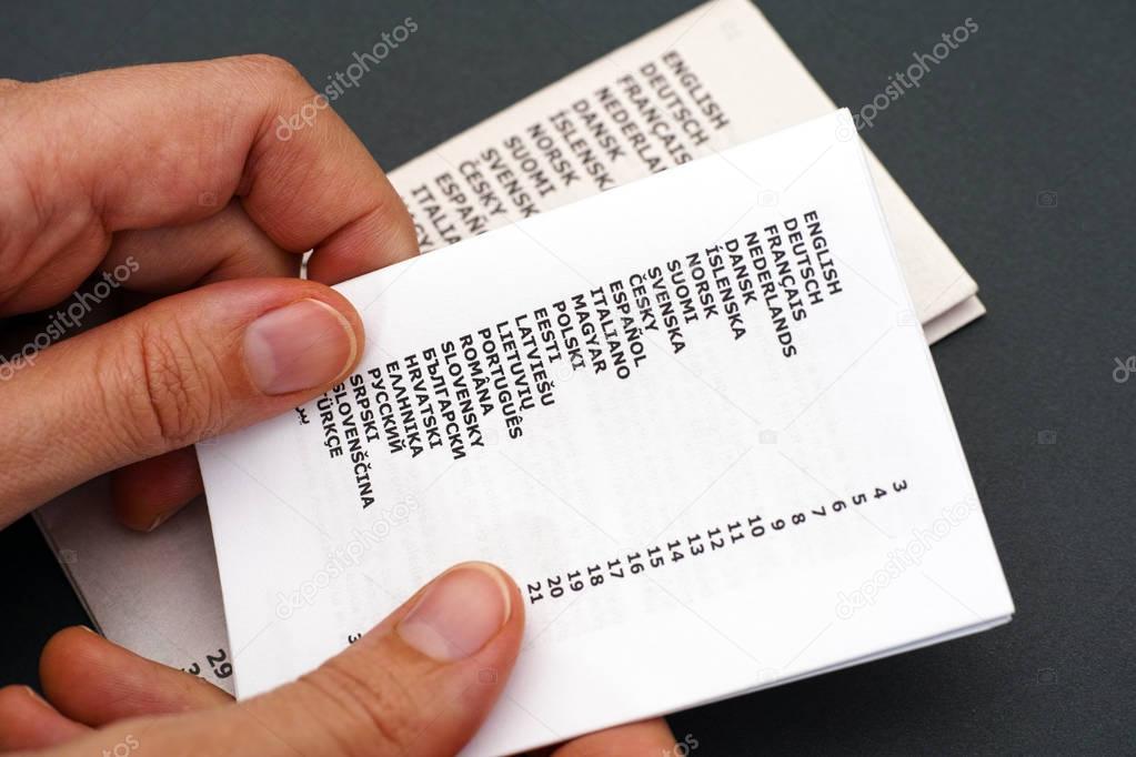 Booklets with list of languages in woman hands