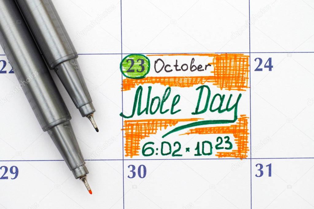 Reminder Mole Day in calendar with two pens